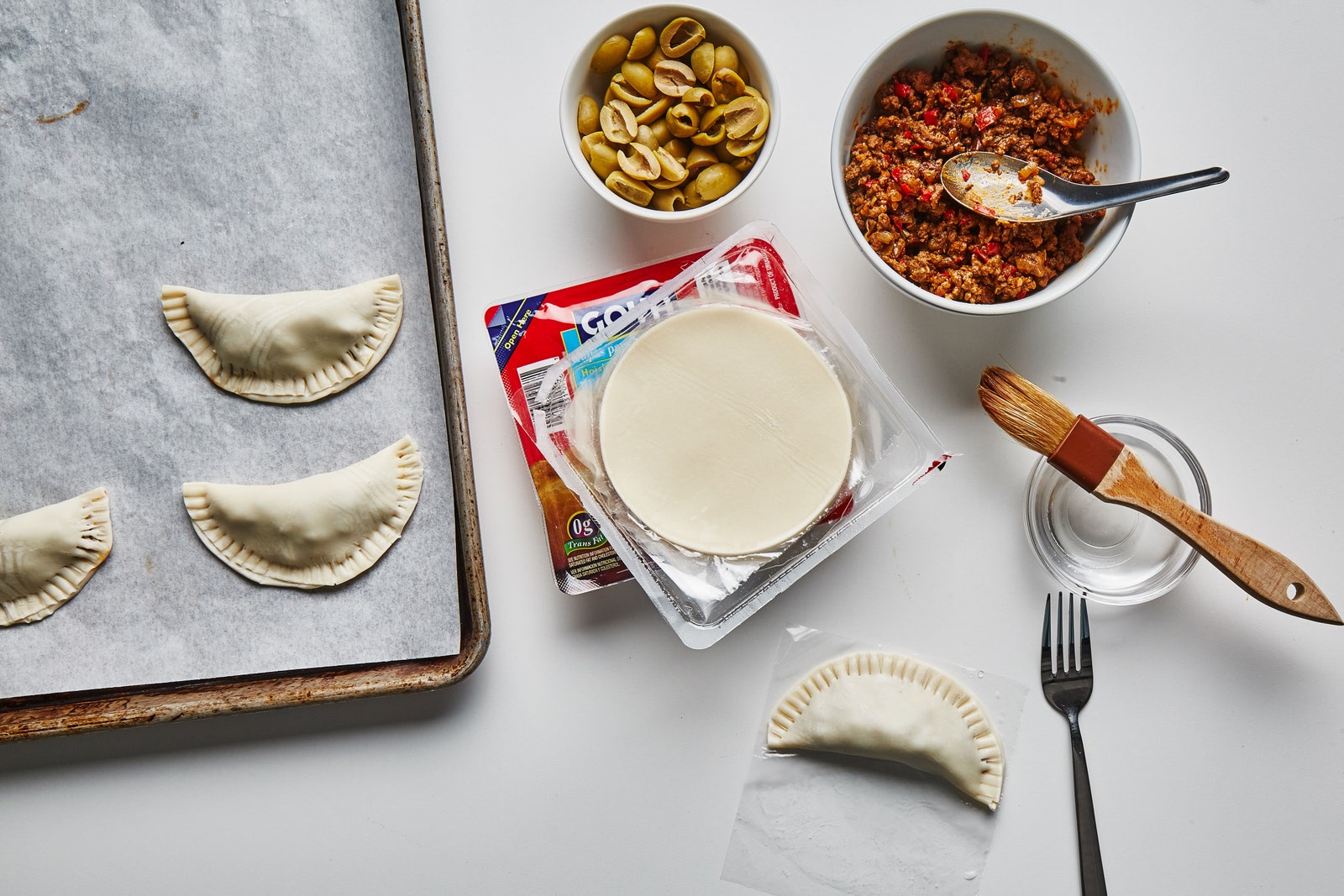 An assembly station for beef empanadas.